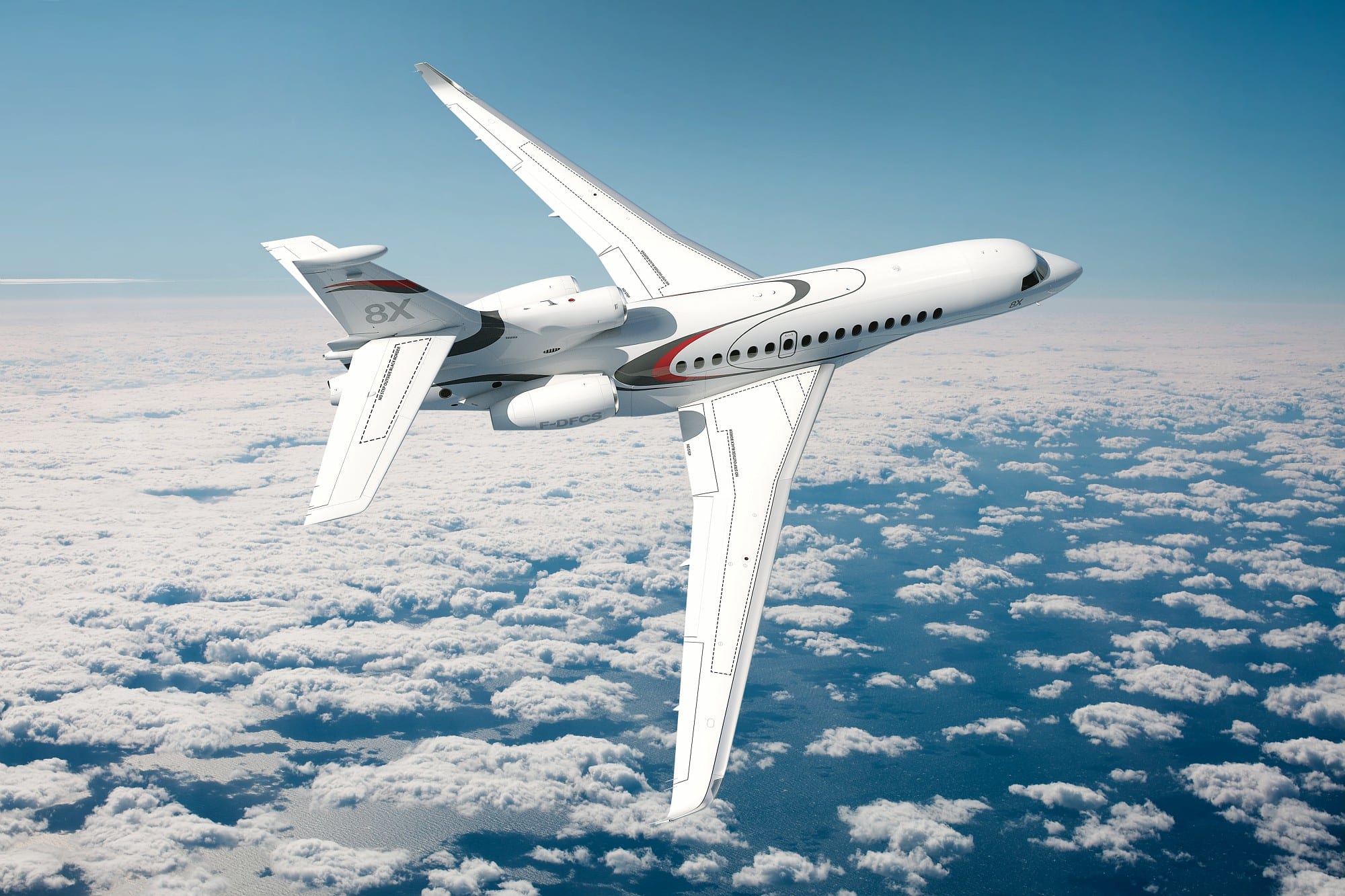 White Dassault Falcon 8X private jet banking above a vast layer of fluffy white clouds.